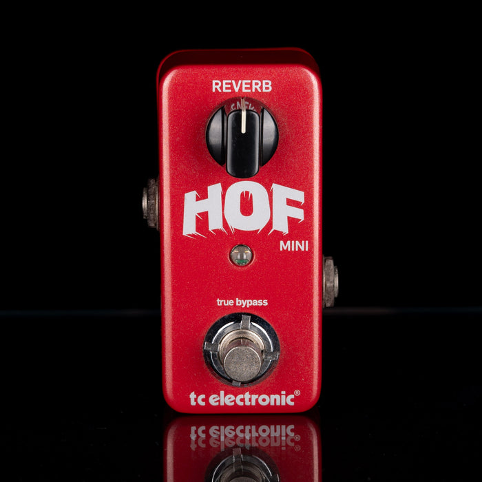 Red guitar effects pedal with 'HOF Mini' and 'tc electronic' branding on a black background