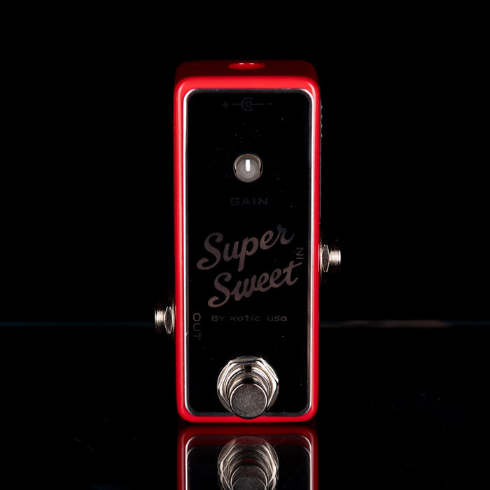 Red guitar effects pedal with 'Super Sweet' branding on a black background