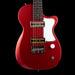 Red electric guitar with a white pickguard on a black background