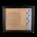 Vintage-style amplifier with a textured front panel and control knobs on a black background