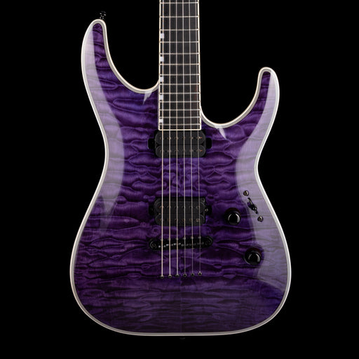 Purple electric guitar with a black pickguard on a white background