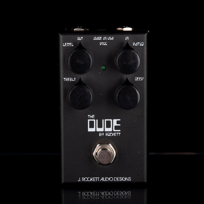 Black guitar effects pedal with 'The Dude' branding on a black background