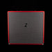 Black guitar amplifier cabinet with red trim on a black background