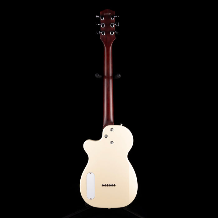 White electric guitar with a dark brown neck on a black background