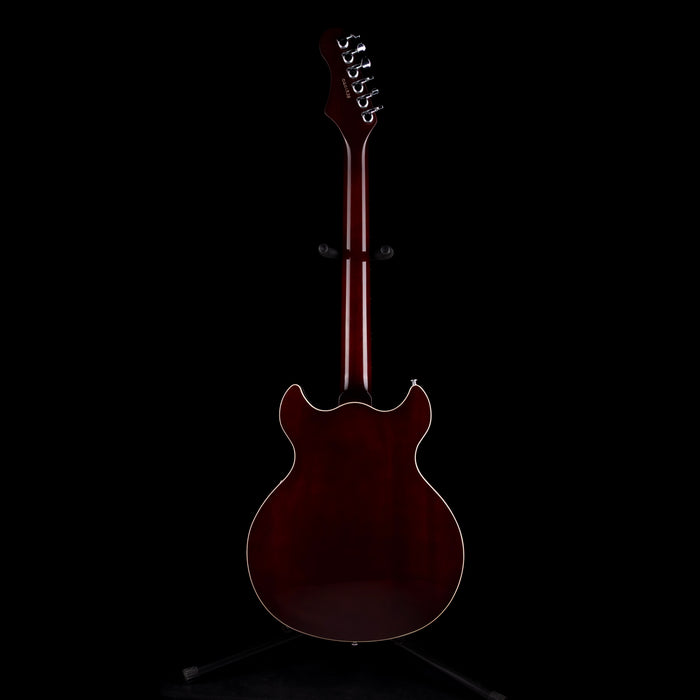 Guitar on a stand against a black background