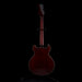 Guitar on a stand against a black background