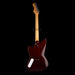 Electric guitar with a dark brown body and light wood neck on a black background