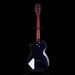 Black electric guitar with a white pickguard on a black background