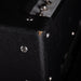 Close-up of a black guitar amplifier with visible screws and text.