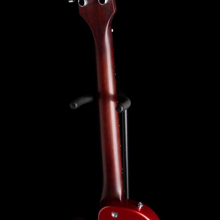 Close-up of a red guitar neck on a black background