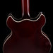 Close-up of a guitar's back on a black background