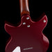 Close-up of a red electric guitar with a dark background