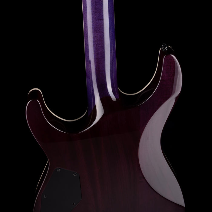 Close-up of a guitar with a dark purple body and white pickguard on a black background