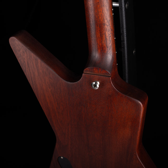 Close-up of a wooden guitar body with a dark background