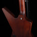 Close-up of a wooden guitar body with a dark background