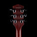 Close-up of a guitar headstock with tuning pegs on a black background