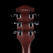 Close-up of a guitar headstock with tuning pegs on a black background