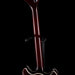Close-up of a guitar neck and headstock on a black background