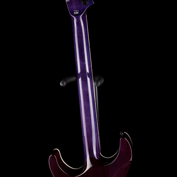 Purple electric guitar on a black background