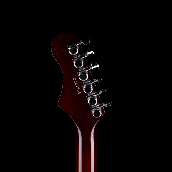 Guitar headstock with brand name on a black background