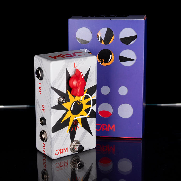 Guitar effects pedal with colorful design and matching box on a reflective surface.