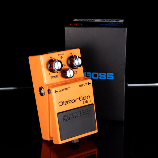Orange BOSS DS-1 Distortion guitar effects pedal on a black background