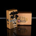Guitar effects pedal with 'Echorec' branding next to its packaging on a reflective surface.