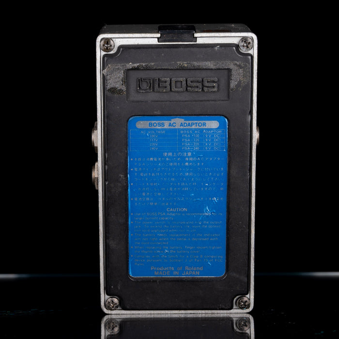 BOSS AC adapter with blue label on a black background