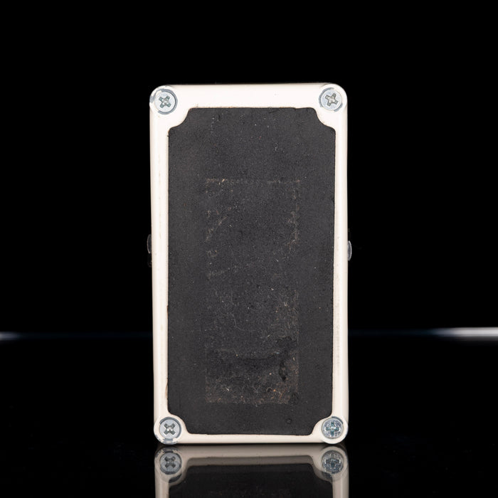 Rectangular metal object with textured surface on a black background