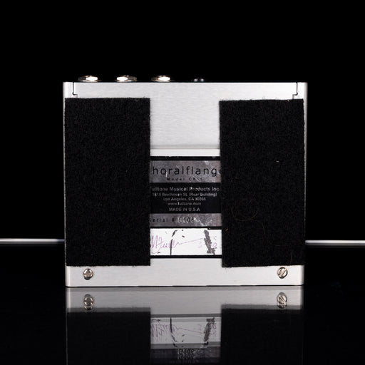Black and white cassette tape with visible branding on a reflective surface.