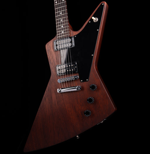 Wooden electric guitar with a unique body shape on a black background