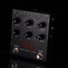 A close-up of a black Trio Band Creator+ Looper guitar effects pedal with multiple rotary knobs, switches, and foot pedals against a dark background.