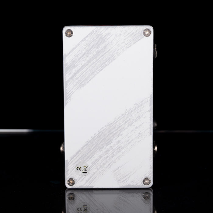 Metallic rectangular object with textured surface on a black background