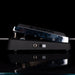 Guitar pedal with blue and black design on a reflective surface