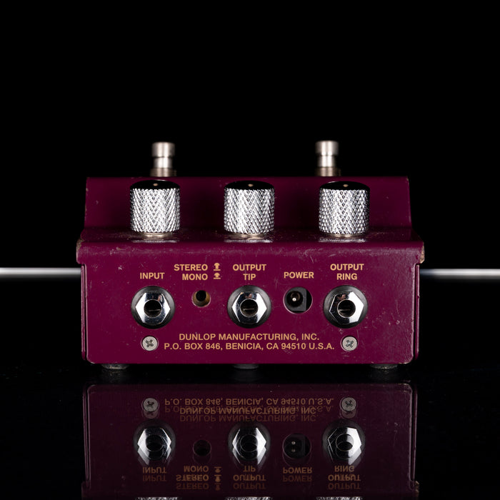 Guitar effects pedal with multiple jacks on a reflective surface