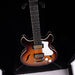 Electric guitar with a sunburst finish on a black background