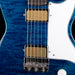 Close-up of a blue electric guitar with a white pickguard