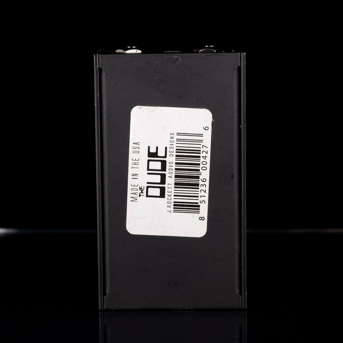 Black box with a label featuring 'The Dude' branding on a black background