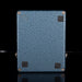 Blue textured rectangular object with screws on a black background