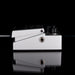 Metallic pedal with two knobs and a jack plug on a black background