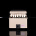 Beige laboratory device with multiple small containers on a black background