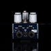 Guitar effects pedal with control knobs and input/output jacks on a black background