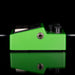 Green guitar effects pedal with black components on a reflective surface