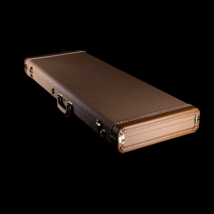 Brown guitar case on a black background
