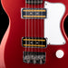 Close-up of a red electric guitar with a white pickguard