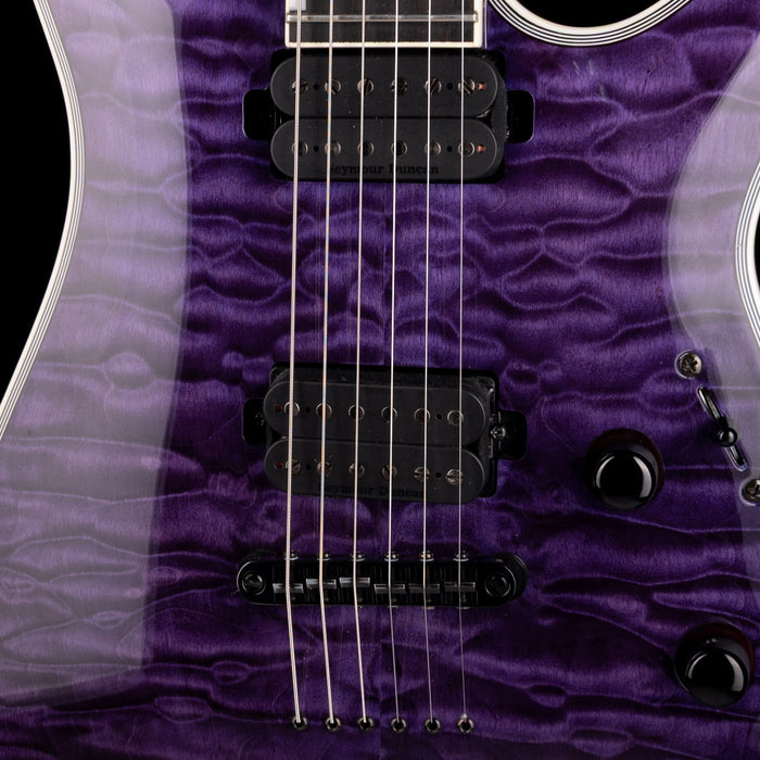 Close-up of a purple electric guitar with a focus on the neck and tuning pegs.