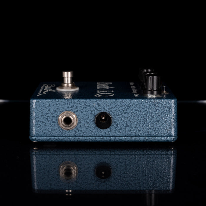 Blue guitar effects pedal with visible brand name on a black background