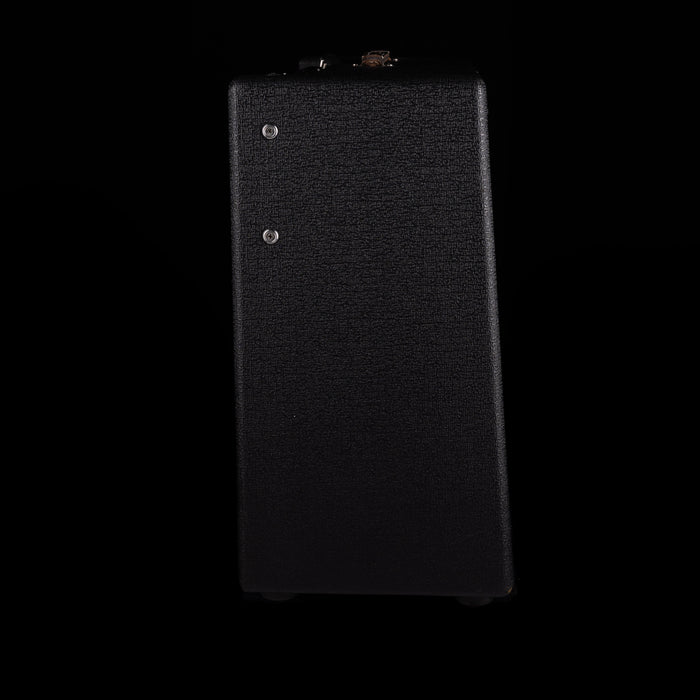 Black rectangular object with textured surface on a black background