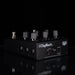 A black DigiTech audio effects pedal with multiple silver and black knobs, shown on a reflective black surface against a black background.