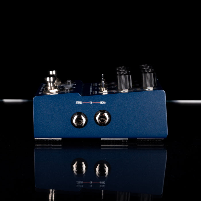 Blue audio interface with knobs and labels on a black background